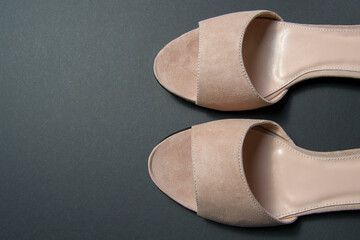 women's shoes of beige color on a black background. shoes removed from the top