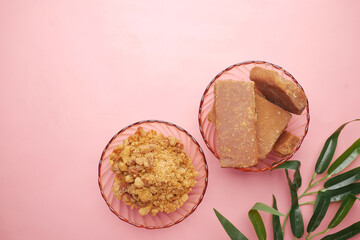 stack of Jaggery traditional cane sugar cube on pink 