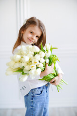 Portrait of beautiful pretty girl with white flowers tulips. Ind