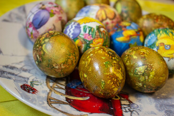 colorful Easter eggs on a plate with a yellow background..eggs for the Easter holiday.