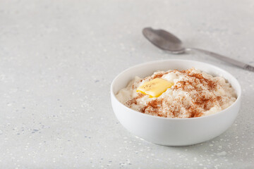 rice pudding with butter cinnamon. french riz au lait, norwegian risgrot, traditional breakfast dessert