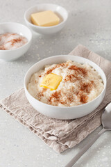 rice pudding with butter cinnamon. french riz au lait, norwegian risgrot, traditional breakfast dessert