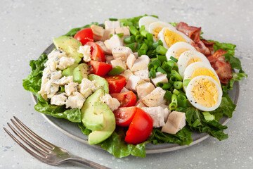 healthy American Cobb salad with egg bacon avocado chicken tomato. hearty keto low carb diet