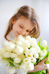 Obraz na płótnie Canvas Portrait of beautiful pretty girl with white flowers tulips. Ind
