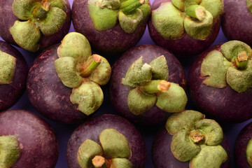 Delicious fresh mangosteens on color background, closeup