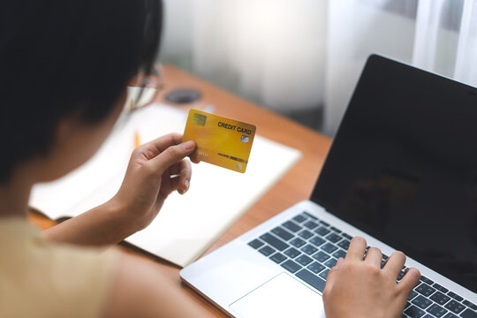 Young adult woman stay at home hand holding credit card for shopping online and e-commerce. - Powered by Adobe