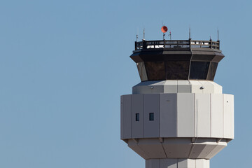 Closeup of air traffic control tower from a small airport against a bright blue sky