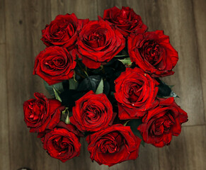 expensive bouquet of large red roses. low key photography, noir