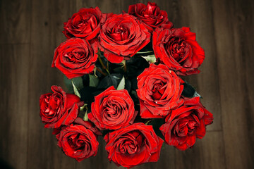 expensive bouquet of large red roses. low key photography, noir