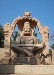 Fototapeta premium Narasimha Lakshmi temple Hampi antique stone art close-up shot from the unique angle with amazing sky image is taken at Hampi Karnataka India. This temple features the biggest effigy in Hampi.