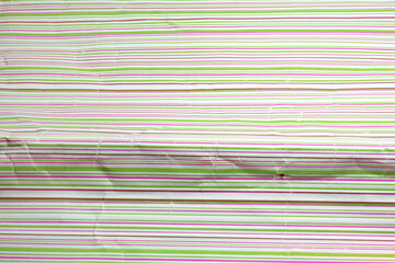 colorful striped crumpled wrapping paper for gifts. bright texture of horizontal stripes closeup