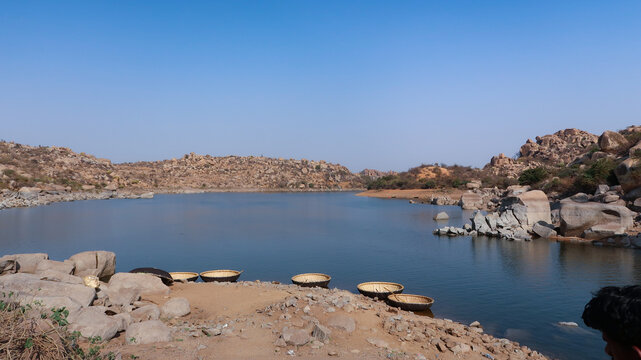 Scenic coracle ride on the Tungabhadra River in Hampi offers stunning views of rocky landscapes, ancient ruins, calm waters, and the timeless beauty of Karnataka&rsquo;s heritage.