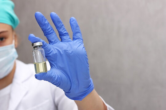 A medical worker holds a bottle of vaccine. Coronavirus. Vaccination.