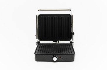 electric grill on a white background. mode wheel and electric grill control panel. household appliances.folding grill. modern electric grill