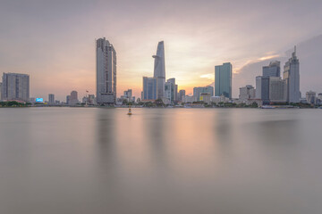 Fototapeta na wymiar Place: Ho Chi Minh City, Vietnam. Time: April 30, 2021. When the sunset comes, the author noticed that the color of the sky has a huge change, the photo of the architecture shows that vividly.