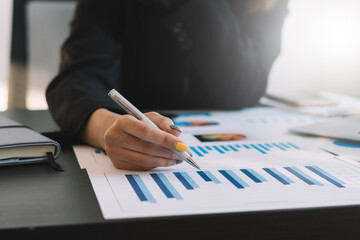 Business people or accountants are analyzing graphs on finance, investment, graph chart business strategy ideas, data analysis technology.