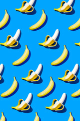 Banana pattern in hard light on blue background