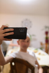 A Muslim boy taking a selfie while having an iftar during Ramadan