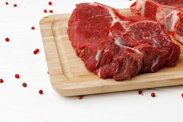 Beef tenderloin on wooden board on wooden table