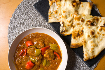 typical dish of Indian cuisine Rogan Josh with naan. view from top