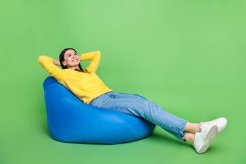 Portrait of attractive cheerful glad girl sitting on bag chair resting spending day weekend...