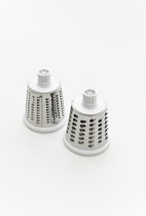 mechanical grater three in one on a white background. grater with nozzles. kitchen appliance for cutting vegetables.