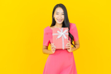 Portrait beautiful young asian woman smile with red gift box