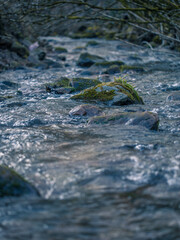 Close up of a river flowing over a stone