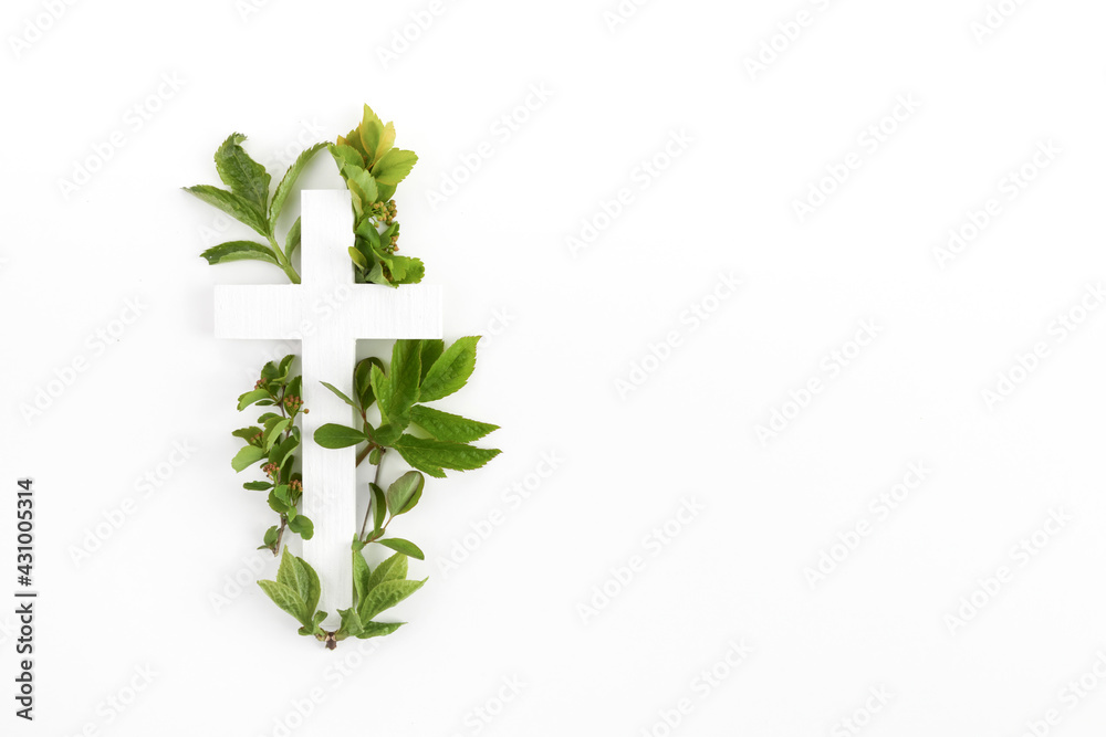 Wall mural The Christianity cross of green leaves. Baptism, Easter, church holiday background