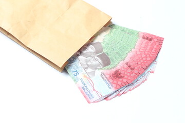 Rupiah Paper Money, 75000 at Brown Envelope at White Background