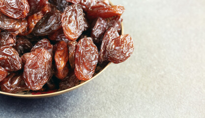 Close up picture of jumbo raisins in a bowl, selective focus.