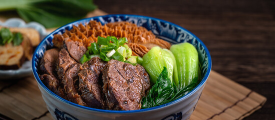 Taiwanese famous food beef noodle soup on wooden table.
