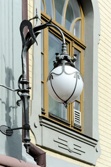 Decorative hanging street lantern mounted on the wall