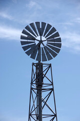 Electric power generating windmill wheel on a metal tower construction