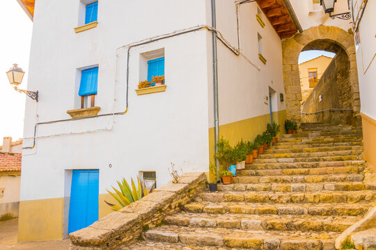 Villafranca del Cid, Alt Maestrat, Castell&oacute;n, Valencian Community, Spain. Beautiful medieval historic village. Street going through a portico (archway) with ancient stone stairs.