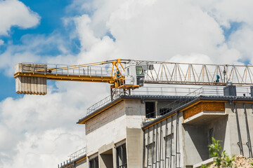 Belarus, Minsk - May 28, 2020: Tower crane and urban modern building under construction at a industrial site