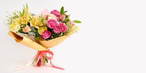 Beautiful flowers in vase on a table with white background. Women's, mother's day, love concept. Spring, summer season.