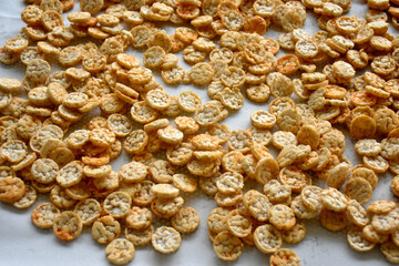 Popped Japanese brown rice is ground into powder, then made into a round disk, then crispy until golden brown and then dried. 
