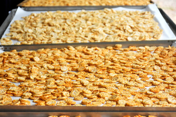 Popped Japanese brown rice is ground into powder, then made into a round disk, then crispy until golden brown and then dried. 