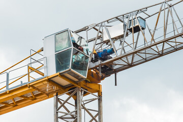 Tower equipment industrial crane cabin close-up on sky background or construction site