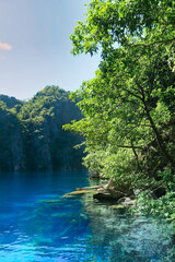 Hidden crystal clear turquoise water lake in the Philippines in summer