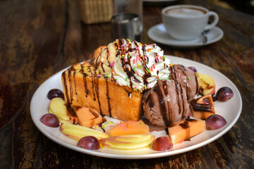 Bread and ice cream are arranged in a white plate under the name 