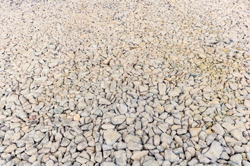 Various irregularly shaped, compacted stones as the basis for future asphalt pavement