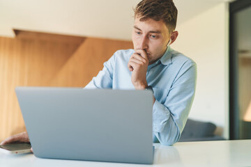 Successful business man working from home with laptop and smartphone