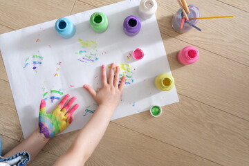 Painted rainbow on children's palms. The child draws with finger paints. Concept art. 