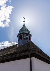 Old church and striking clock in sunshine in Germany