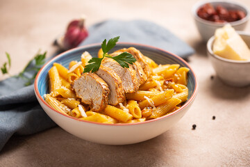 Pasta penne with cajun sauce and fried chicken