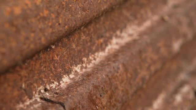 Closeup of rust on iron surface. Oxidized metal sheet. Vertical video