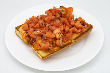 Two Large Pieces of Bruschetta on a White Plate