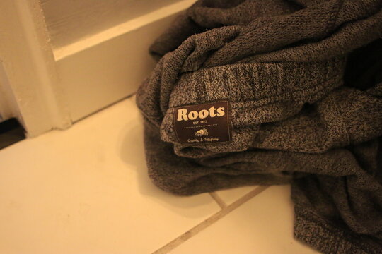 London Canada, November 16 2020: Editorial Illustrative Photo Of Dirty Roots Sweatpants On Ground. Roots Is A Canadian Brand